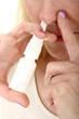 woman spraying nasal spray 1 woman spraying nasal spray 1