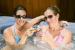 two young women relaxing in a jacuzzi two young women relaxing in a jacuzzi