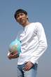 young asian man with a globe