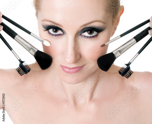 Photo : female face with cosmetic makeup brushes female face with cosmetic makeup brushes