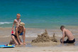 happy family building sand castles on the beach