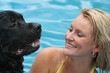 woman swimming with dog woman swimming with dog