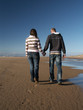 couple holding hands on beach