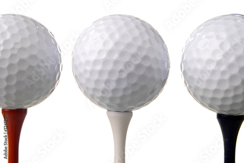 Photo: three golf balls on tees three golf balls on tees