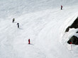 skiers sking down blue run