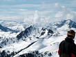 man looking across ski slopes