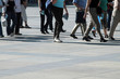 a crowd of pedestrians moving along the sidewalk a crowd of pedestrians moving along the sidewalk