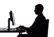 silhouette of man working computer