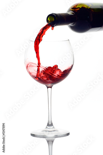 Photo: red wine pouring down from a wine bottle red wine pouring down from a wine bottle