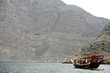dhow by cliff, musandam peninsula oman