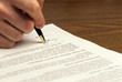 man signs document man signs document