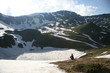 lady watching a frozen mountain lake