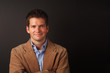 smiling man with brown jacket