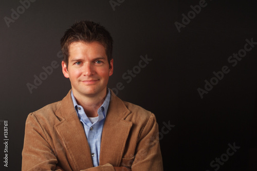 Photo: smiling man with brown jacket smiling man with brown jacket
