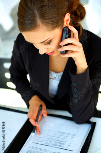 Photo: young businesswoman working at a restaurent of cafe location young businesswoman working at a restaurent of cafe location
