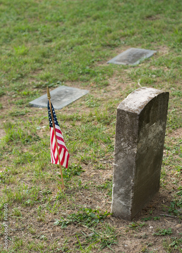 Photo: tombstone and us flag tombstone and us flag