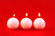 three white candles on red three white candles on red