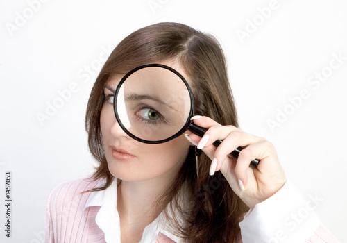 Photo: young woman with magnifying glass young woman with magnifying glass