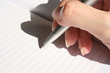 hand holding pen writing on paper
