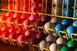 miniature golf balls in a rack