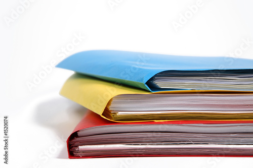 Photo: stack of colorful binders in a office stack of colorful binders in a office