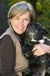 woman holds a dog