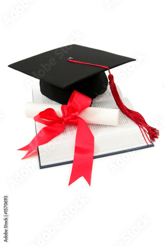 graduation cap and diploma on a book