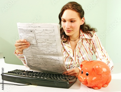 Photo: woman reading business statistics woman reading business statistics