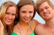 two women and a man on the beach