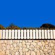 white fence on stone wall white fence on stone wall