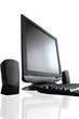 lcd screen with speakers and black keyboard reflected from a tab