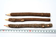 Photo: three unusual pencils made of branches near to a measuring ruler three unusual pencils made of branches near to a measuring ruler
