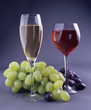 two goblets with wine and grape
