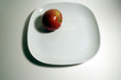 an aple on the edge of a plate