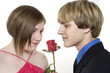 adorable teen couple looking at rose
