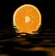 sliced orange isolated on black background