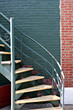 green brick house with staircase