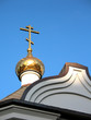 the gilt dome and cross of an orthodox chapel on a decline