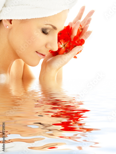 lady with red petals in water