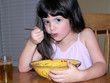 child eating soup