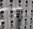 3d rendering - a wall of safes, one opened