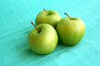 three deluxe wet green apples