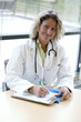 Photo: female medical professional writing female medical professional writing
