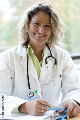 Photo: female medical professional writing female medical professional writing