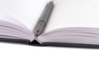 black felt-tip lying on opened notebook