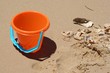 bucket on beach with shells bucket on beach with shells