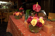 wedding reception with orange, pink and red roses