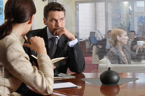 Photo: interview thinking business man & woman in office interview thinking business man & woman in office