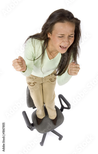 Photo: screaming woman standing on the office chair screaming woman standing on the office chair