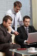 young business men working with latop in office young business men working with latop in office